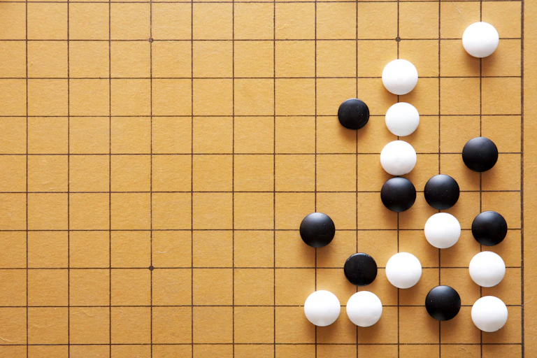 Go playing pieces on a board