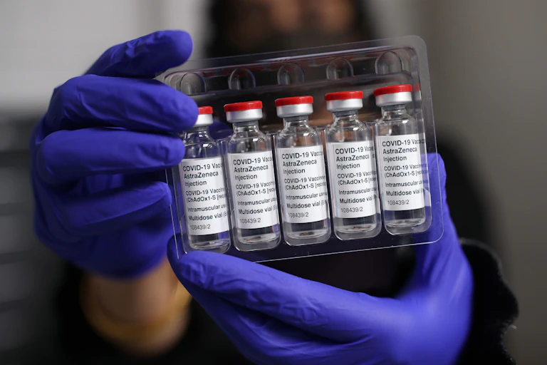 Person holding up AstraZeneca vaccine
