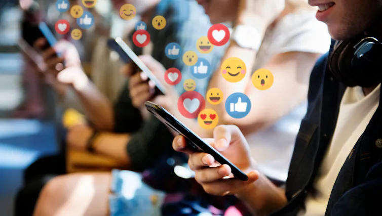 A row of people on phones, emoticons.