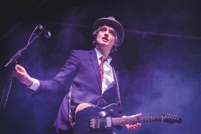 Pete Doherty performing on stage.