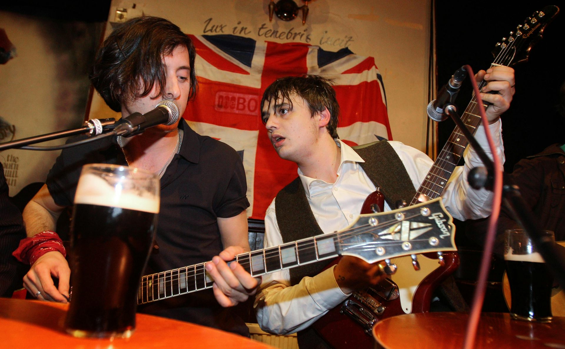 Carl Barat and Pete Doherty playing a gig.