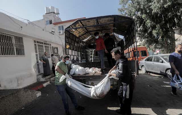 Relatives gather at Al-Shifa hospital in Gaza city to identify bodies.