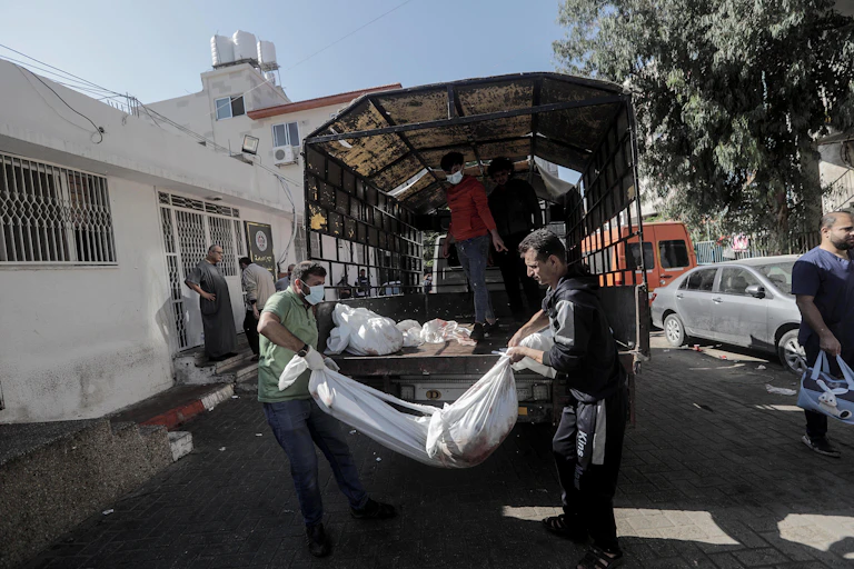 Relatives gather at Al-Shifa hospital in Gaza city to identify bodies.
