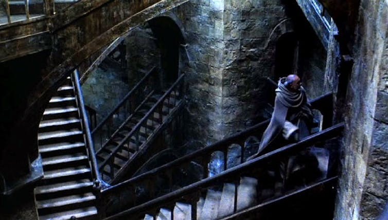 The interior of a stone building, with winding stairs.