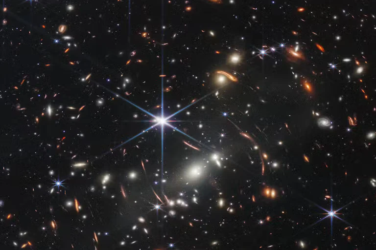 Lots of galaxies shown as small points of light against a dark backdrop.
