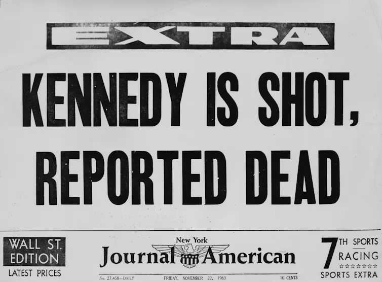 A newspaper headline that reads 'KENNEDY IS SHOT, REPORTED DEAD'