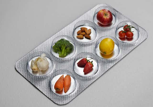 A photo showing a medicine-style blister pack filled with fruit and vegetables.