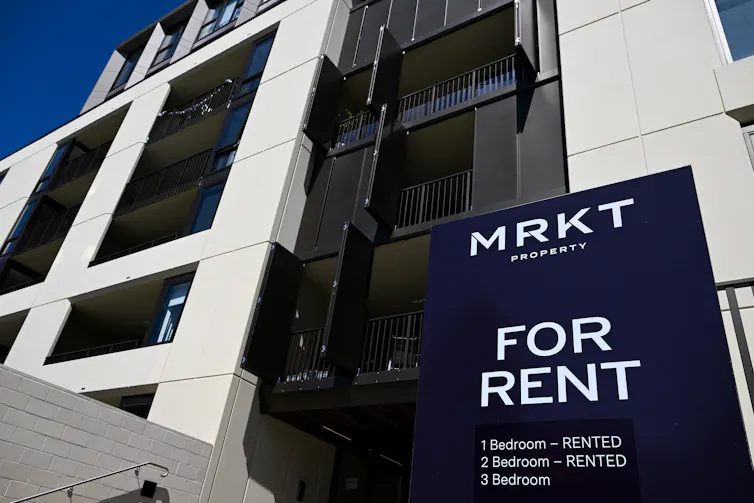 A for rent sign in front of an apartment building