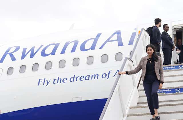 Former home secretary Suella Braverman walking down the stairs of a RwandaAir plane