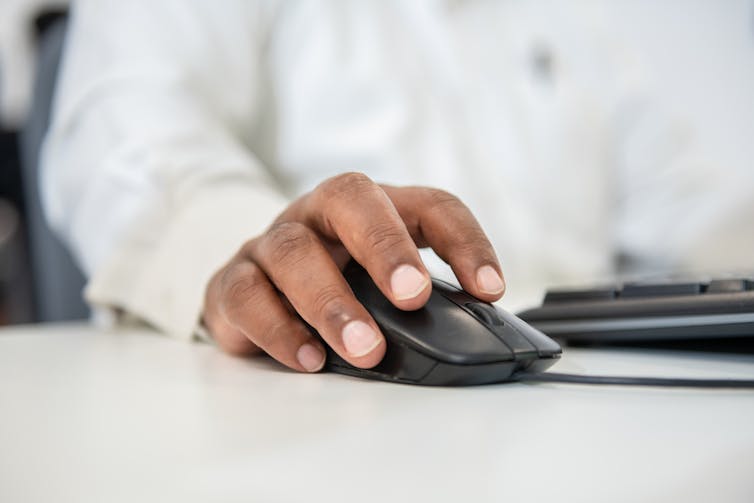 A hand using a computer mouse.