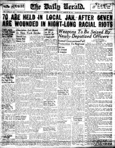 A newspaper headline says 70 people were jailed after a night long racial riot.