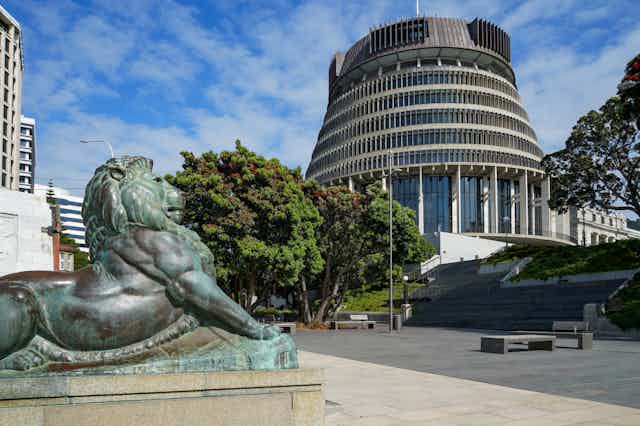 New Zealand Beehive with lion stature in foreground.