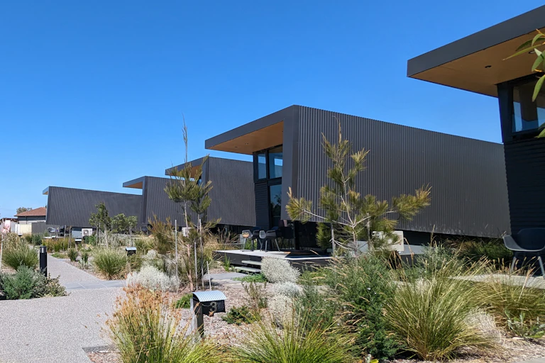 A row of modern units in native gardens