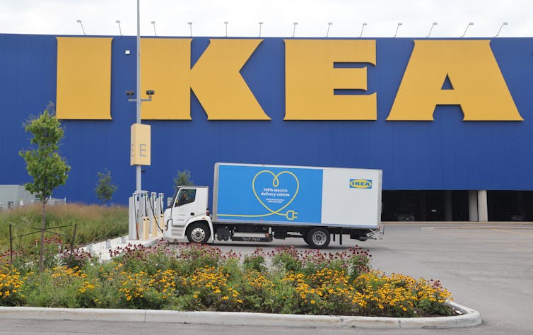 A truck charges with a large IKEA logo in the background.