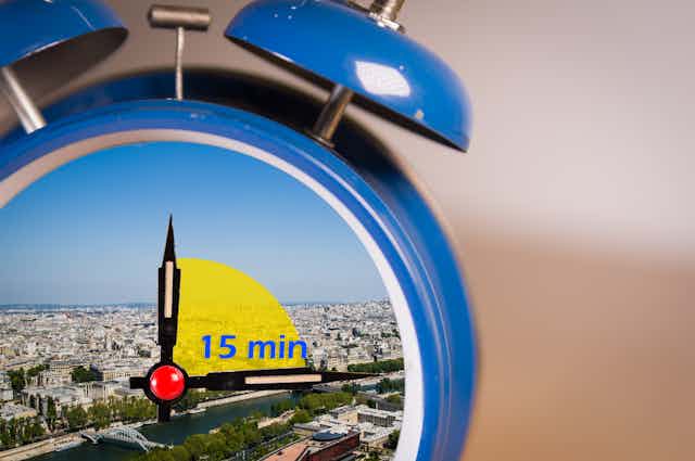 an alarm clock with a 15-minute timer and the background of a city
