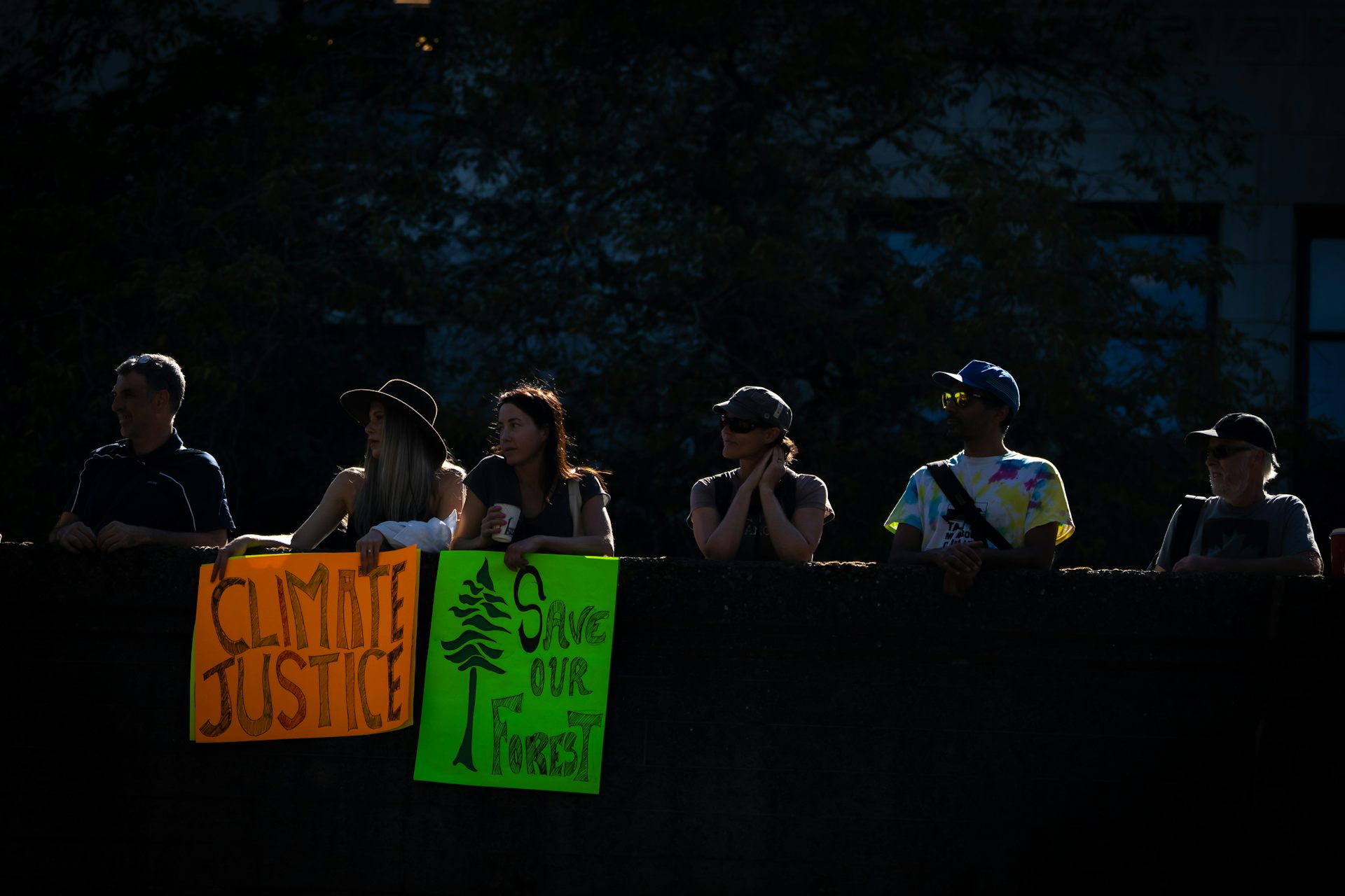 People on a bridge with signs protesting climate change