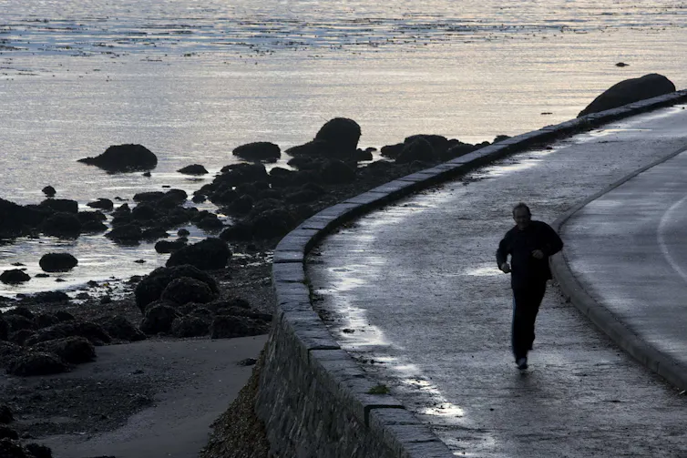 A jogger makes his way around the seawall of Vancouver's Stanley Park.