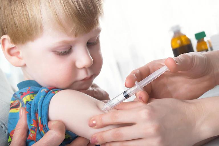A child receive a vaccine from their doctor.