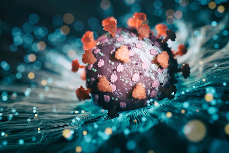 Illustration of COVID-19 virus burrowing into the surface of a cell