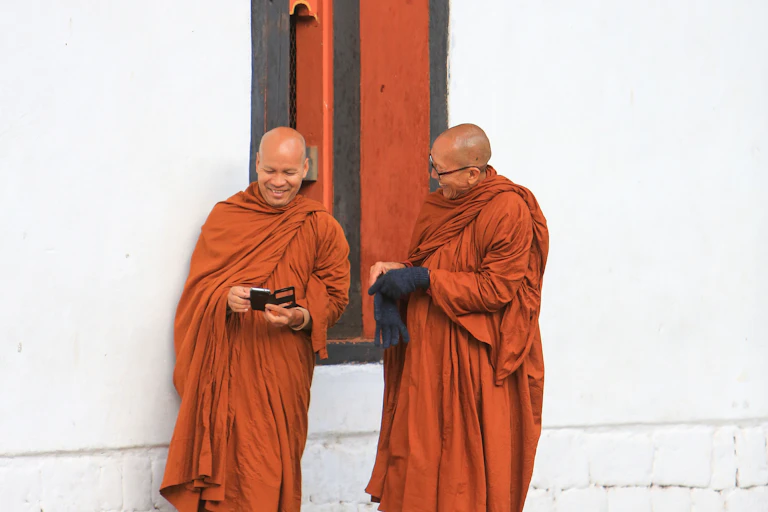 Buddhist monks checking their mobile phones