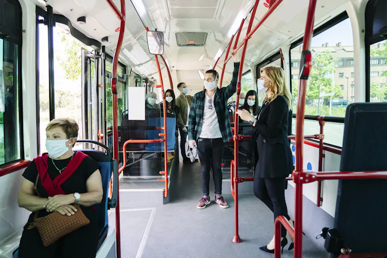 People on public transport wearing masks.