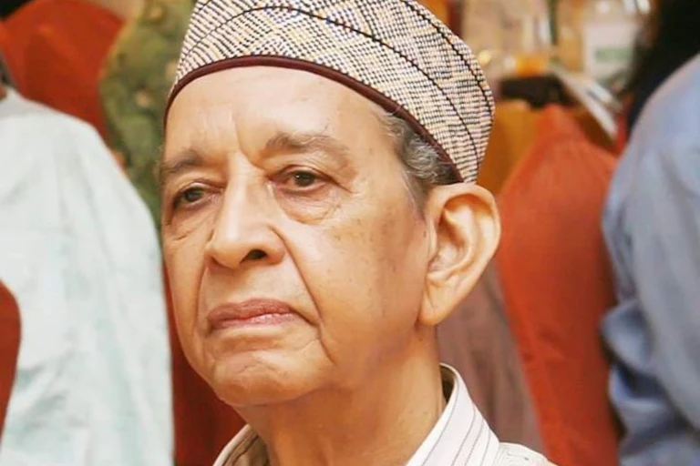 Photo of the head of an elderly man wearing a cap.