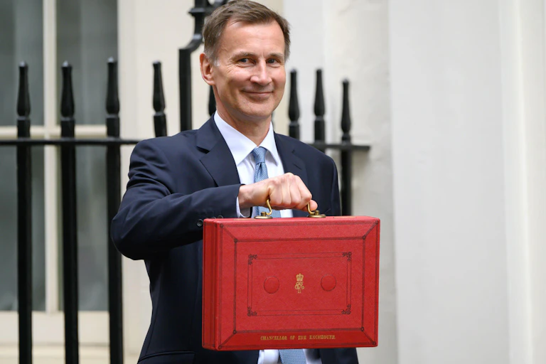 Jeremy Hunt holding up the red briefcase