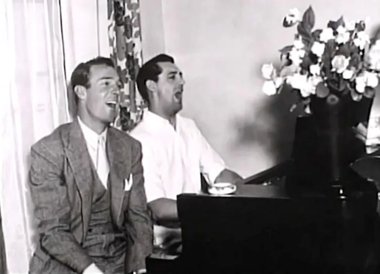 Randolph Scott and Cary Grant playing music at their home.
