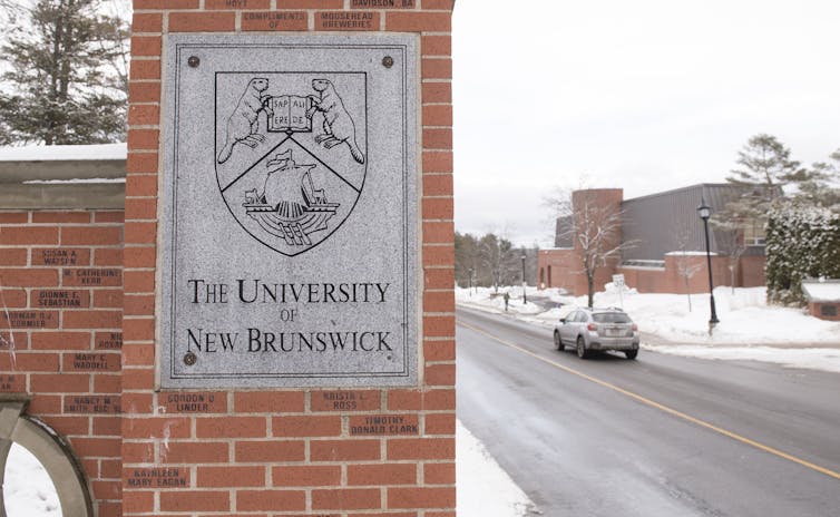 A gate seen with a sign saying University of New Brunswick.