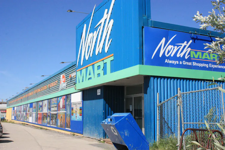 A storefront seen against a clear blue sky.