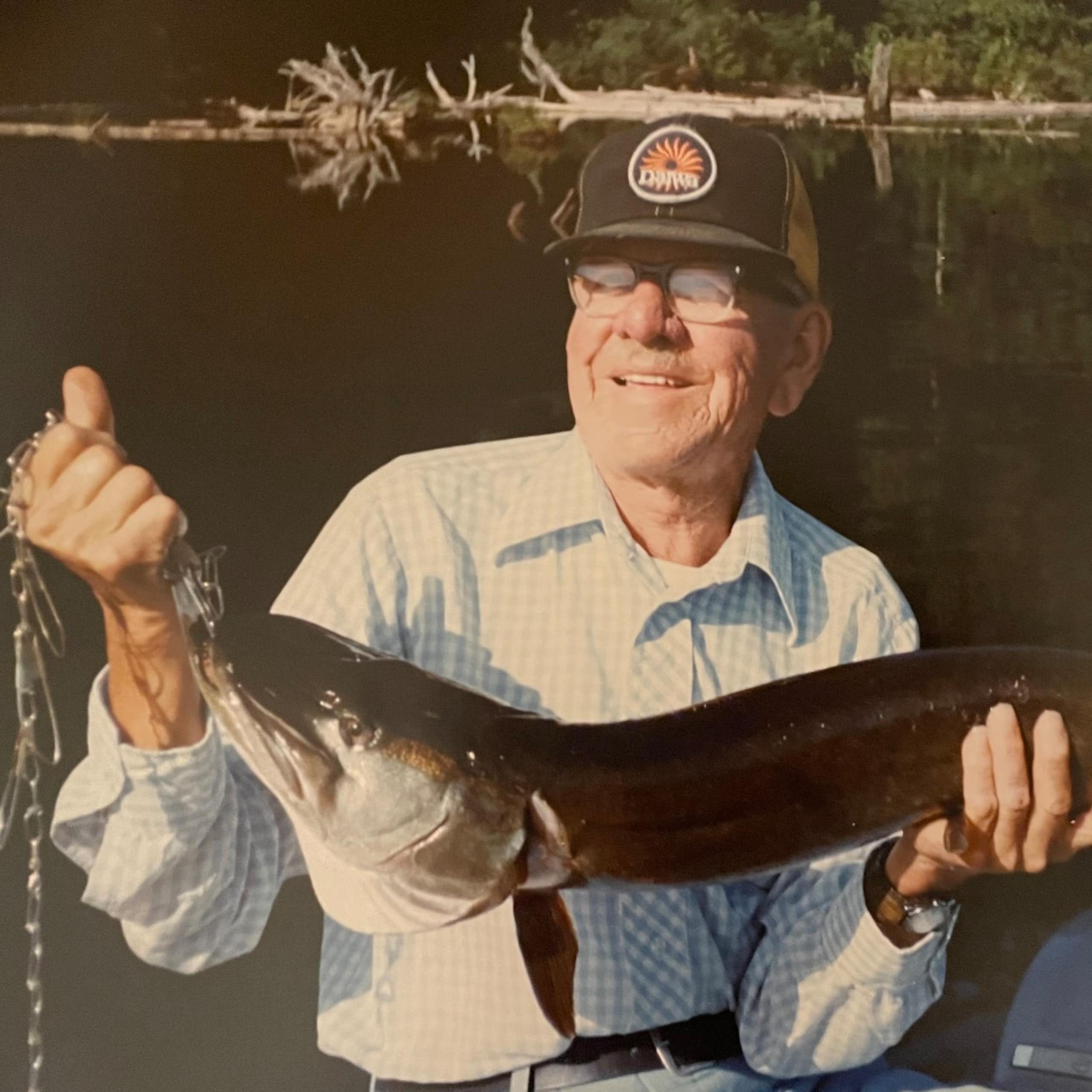 A man seen holding a fish.