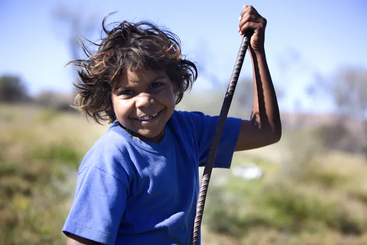 Aboriginal child smiles while playing
