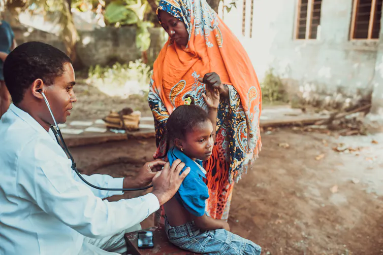 Doctor examines child's back