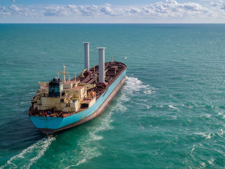 A cargo vessel with two cylinders rising from the deck.