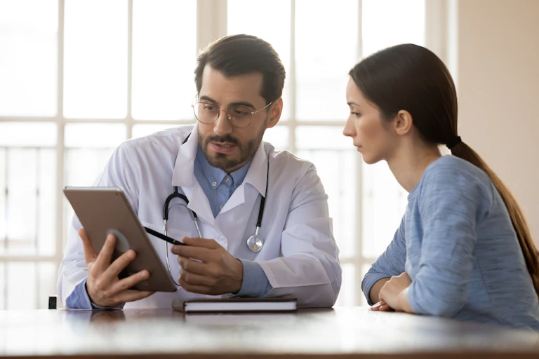 Doctor pointing to something on an tablet computer