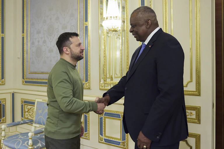 Ukrainian president Volodymyr Zelensky shakes hands with US defense secretary Lloyd Austin as they meet in Kyiv, Novembe 2023.