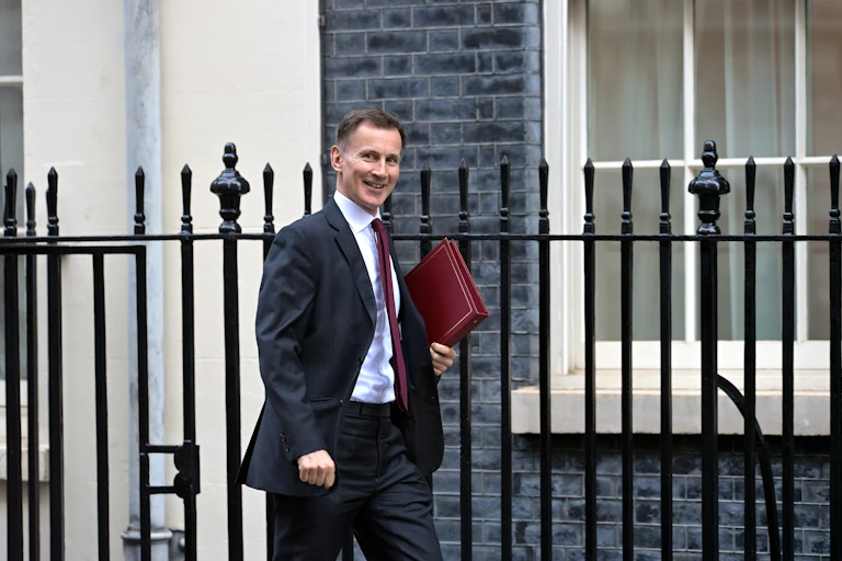 Jeremy Hunt walks along Downing Street, London.