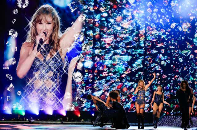 Taylor Swift and signers on stage, Swift on screen, at concert in Brazil