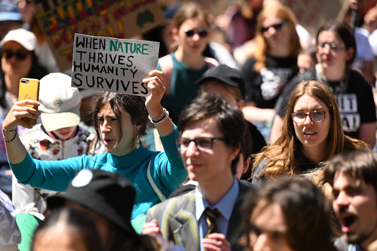 Protesters gather during the School Strike 4 Climate rally at Flagstaff Gardens in Melbourne, November 2023.