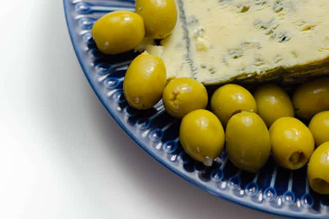 Olives and blue cheese on a plate