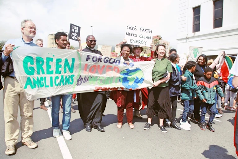 People holding banner at a rally