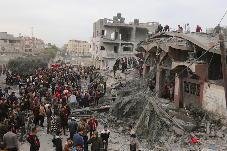 Palestinians search for survivors of an Israeli airstrike at Rafah in the south of the GAza Strip.