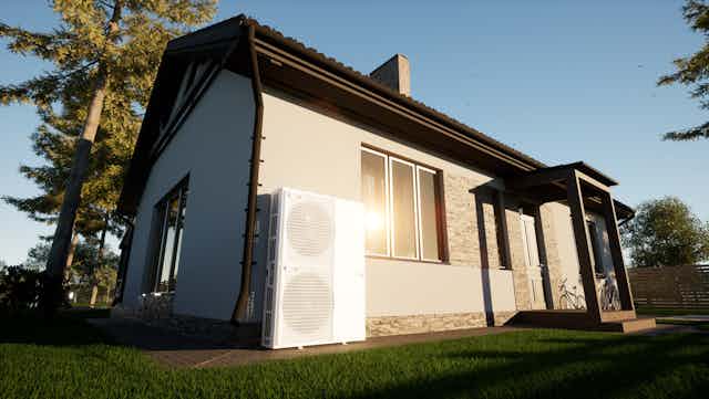 A house with a heat pump attached to the exterior.