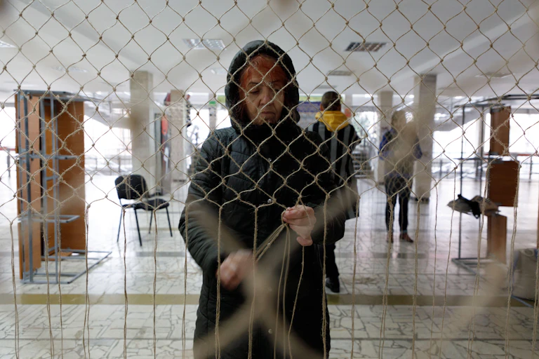 A Ukrainian standing in front of a large net.