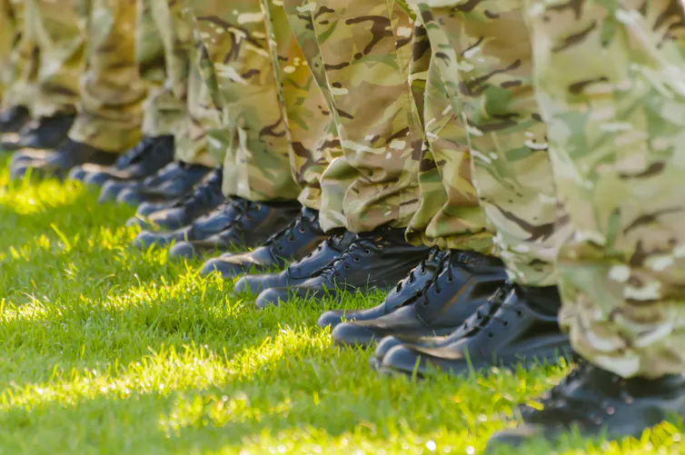 The feet of a row of soldiers standing in a line side by side