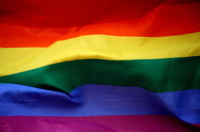 A rainbow flag is shown up close.