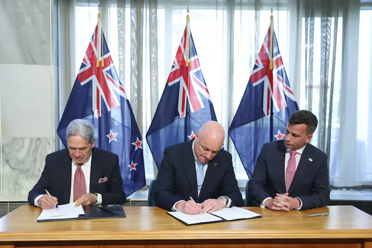 Winston Peters, Christopher Luxon and David Seymour sign their respective coalition agreements.