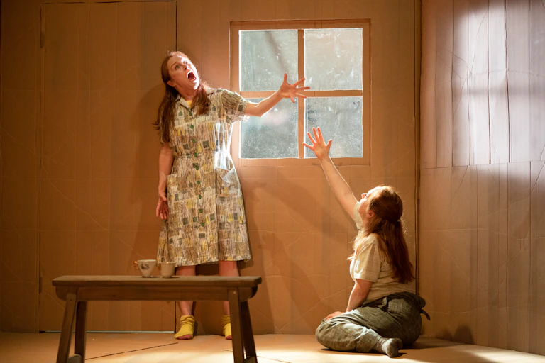 Two sisters emote on stage.