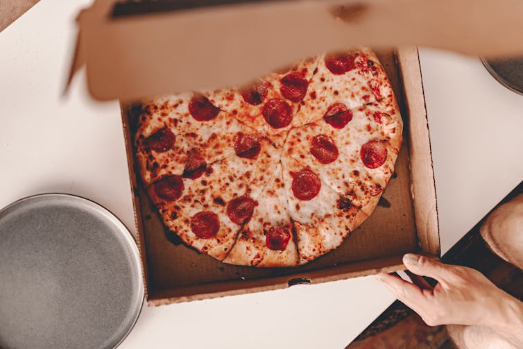 Pepperoni inside cardboard box on table