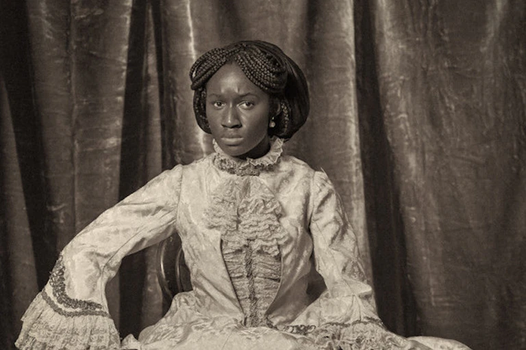 photograph of a black woman dressed in Victorian clothes.